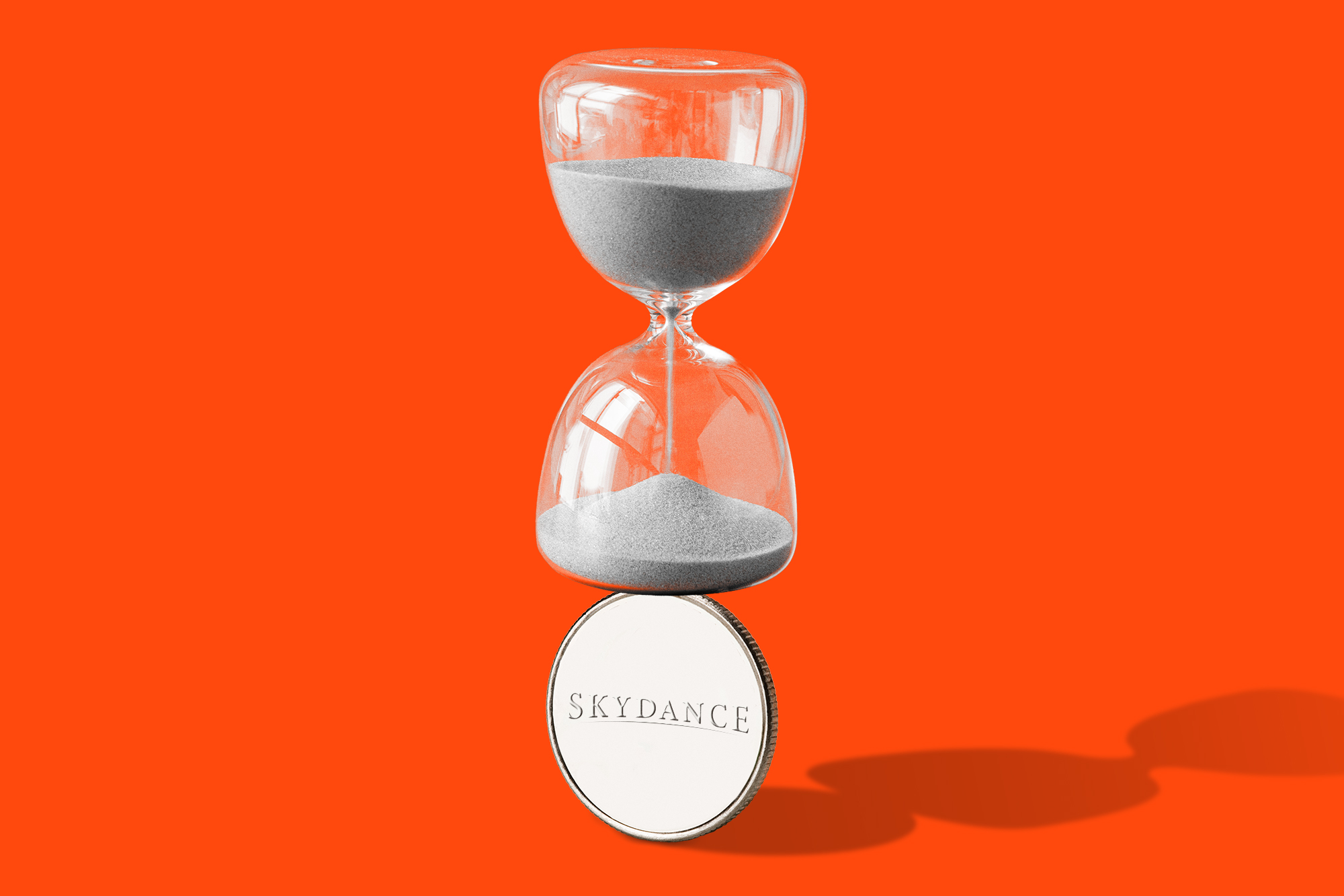 Hourglass balancing on a silver coin with the Skydance logo on it