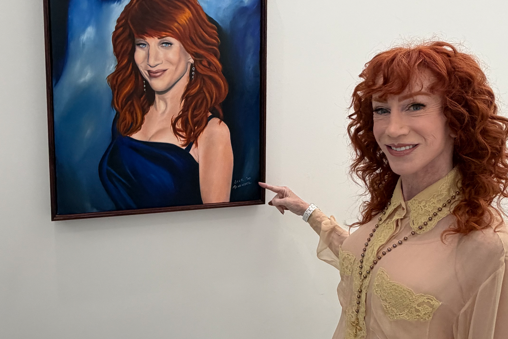 Kathy Griffin points to a painting of herself